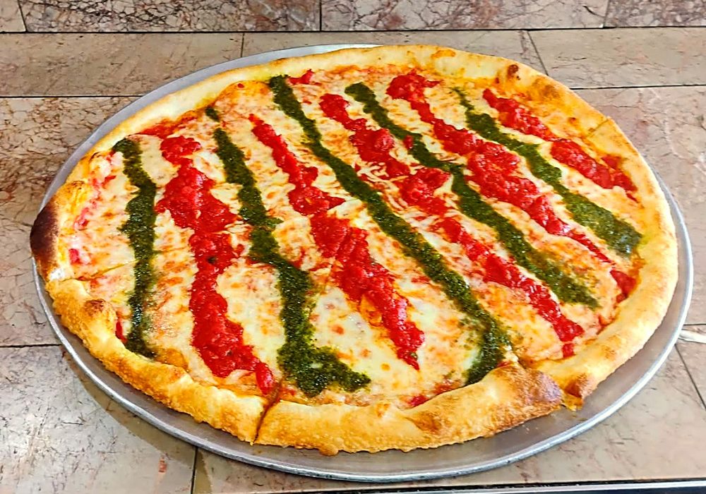 Round pizza striped with red and green sauce